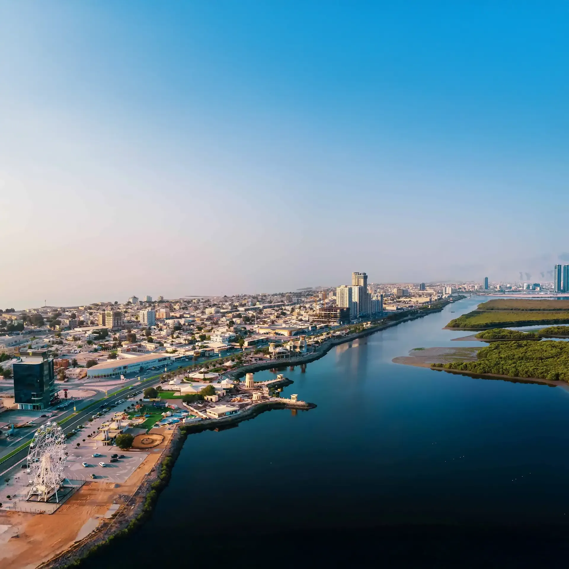 Modern Ras Al Khaimah skyline integrated with green hydrogen energy facilities.